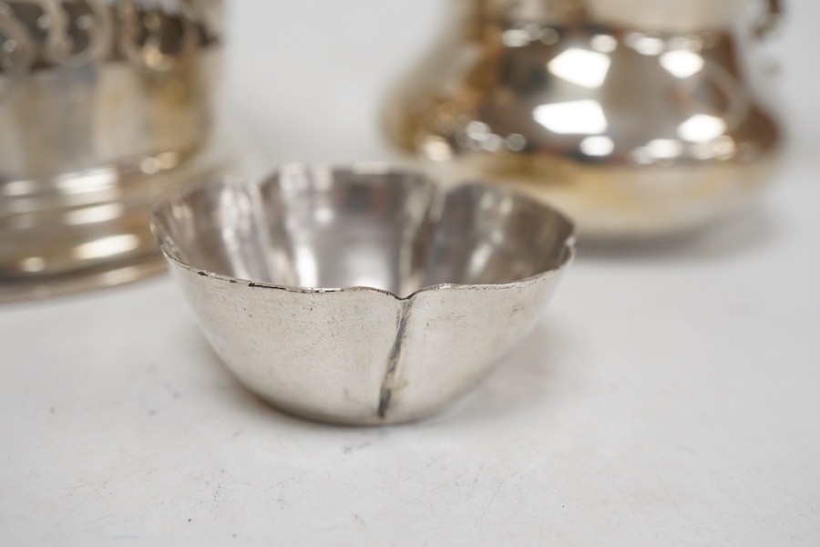 An Italian pierced 900 standard white metal bottle coaster, diameter 99mm, together with a sterling cream jug and a small 925 bowl, 9.9oz.
